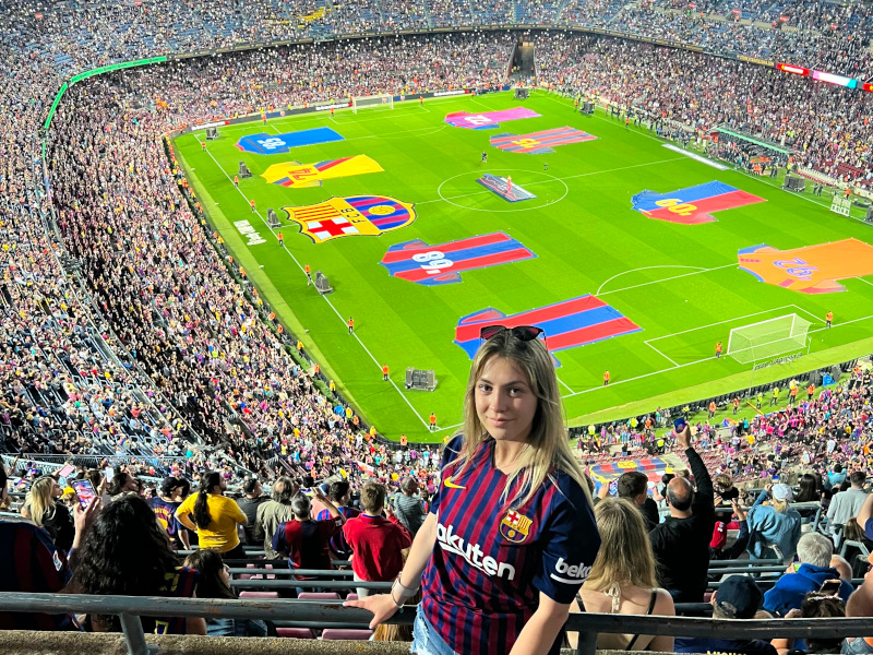 ECS student Elizabeth Velychko stands in a stadium during a FC Barcelona game at Camp Nou stadium in Spain.